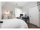 Cozy bedroom with shiplap walls, a comfortable bed, and a functional workspace at 10594 Serenbe Ln, Chattahoochee Hills, GA 30268