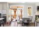 Bright dining area with hardwood floors adjacent to a screened porch, adding charm to the living space at 10594 Serenbe Ln, Chattahoochee Hills, GA 30268