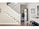 Bright entryway featuring a staircase with decorative railings and arched doorway adding architectural interest at 10594 Serenbe Ln, Chattahoochee Hills, GA 30268