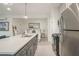 Open living space with a modern kitchen island, seating area, and bed with white linens at 10594 Serenbe Ln, Chattahoochee Hills, GA 30268