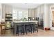 Bright kitchen features stainless steel appliances, a center island with seating and ample counter space at 10594 Serenbe Ln, Chattahoochee Hills, GA 30268