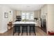 Open kitchen with center island, stainless steel appliances, and ample storage in stylish gray cabinetry at 10594 Serenbe Ln, Chattahoochee Hills, GA 30268