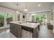 Open living space with a modern kitchen island, comfortable seating, and natural light at 10594 Serenbe Ln, Chattahoochee Hills, GA 30268