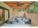 Inviting outdoor patio with comfortable seating, a ceiling fan, and a cozy atmosphere at 10594 Serenbe Ln, Chattahoochee Hills, GA 30268