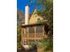 Charming home featuring a large screened porch with arched openings and wood trim at 10594 Serenbe Ln, Chattahoochee Hills, GA 30268