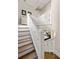 Elegant staircase featuring white railings with diamond accents and hardwood steps, adding a touch of sophistication at 10594 Serenbe Ln, Chattahoochee Hills, GA 30268