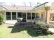View of covered patio area, grill, and above-ground spa surrounded by lawn at 575 Midland Park Dr, Stone Mountain, GA 30087