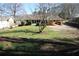 Spacious backyard featuring patio, sunroom, lawn and trees at 575 Midland Park Dr, Stone Mountain, GA 30087