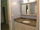 Bathroom featuring a vanity with granite countertop and a decorative mirror at 575 Midland Park Dr, Stone Mountain, GA 30087