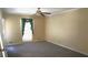 Neutral bedroom featuring a large window providing natural light and carpeted floor at 575 Midland Park Dr, Stone Mountain, GA 30087