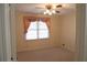 Cozy bedroom with ceiling fan and a window with decorative curtains at 575 Midland Park Dr, Stone Mountain, GA 30087