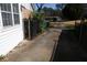 Long concrete driveway with metal gate and side access to the home at 575 Midland Park Dr, Stone Mountain, GA 30087