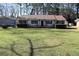 Charming single-story home featuring a well-manicured lawn and inviting front porch at 575 Midland Park Dr, Stone Mountain, GA 30087