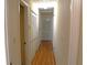 Hallway with hardwood floors, white doors, and access to various rooms at 575 Midland Park Dr, Stone Mountain, GA 30087