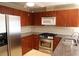 Kitchen featuring stainless steel appliances, granite countertops, and wood cabinets at 575 Midland Park Dr, Stone Mountain, GA 30087