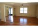 Open living room with hardwood floors, large windows, and ceiling fan at 575 Midland Park Dr, Stone Mountain, GA 30087