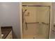 Bathroom featuring a glass enclosed shower with grab bars and tiled walls at 575 Midland Park Dr, Stone Mountain, GA 30087