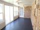 The sunroom showcases brick walls, tiled flooring, a ceiling fan, and sliding glass doors at 575 Midland Park Dr, Stone Mountain, GA 30087