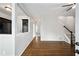 Bright living room with hardwood floors, ceiling fan, and stairs to the second floor at 2162 Larchwood Sw Rd, Atlanta, GA 30310