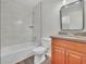 This bathroom features marble-look shower tiles, a wooden vanity and dark flooring at 3183 Abbeywood Dr, Decatur, GA 30034