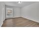 This bedroom features wood flooring and a window with diamond-patterned trim at 3183 Abbeywood Dr, Decatur, GA 30034