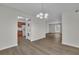 An open dining area featuring wood floors and lighting with views to the laundry area, living room, and kitchen at 3183 Abbeywood Dr, Decatur, GA 30034