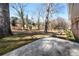 Expansive backyard featuring mature trees and a concrete patio area at 5468 Melanie Sw Ln, Mableton, GA 30126