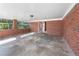 Spacious covered patio with brick walls and a concrete floor at 5468 Melanie Sw Ln, Mableton, GA 30126