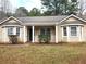 Inviting single-story home featuring manicured lawn, bright windows, and a covered front porch at 130 Willow Shoals Dr, Covington, GA 30016