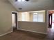 Cozy living room featuring neutral walls, carpet flooring and a partial view of the adjacent room at 130 Willow Shoals Dr, Covington, GA 30016