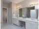 Bright bathroom featuring dual sinks, vanity, and a large mirror with modern lighting at 132 Wetherbrooke Ln # 3, Smyrna, GA 30082