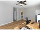 Bedroom featuring hardwood flooring, an open entry to a bathroom, and a ceiling fan at 132 Wetherbrooke Ln # 3, Smyrna, GA 30082