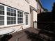 View of the brick patio, with a table and white-trimmed windows, off the deck at 132 Wetherbrooke Ln # 3, Smyrna, GA 30082