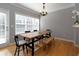 Bright dining room with a wooden table set, a large window with natural light, and hardwood flooring at 132 Wetherbrooke Ln # 3, Smyrna, GA 30082