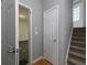 Hallway featuring carpeted stairs leading up and an open doorway to another room at 132 Wetherbrooke Ln # 3, Smyrna, GA 30082