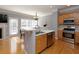 Modern kitchen featuring stainless steel appliances, wood cabinets, light countertops, and hardwood floors at 132 Wetherbrooke Ln # 3, Smyrna, GA 30082