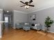 Comfortable living room with hardwood floors, a stylish sofa, a leafy plant, and lots of natural light at 132 Wetherbrooke Ln # 3, Smyrna, GA 30082