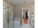 Well-appointed main bathroom with a glass-enclosed shower, a soaking tub, and an open doorway to the bedroom at 132 Wetherbrooke Ln # 3, Smyrna, GA 30082