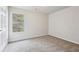 Comfortable carpeted bedroom bathed in natural light from a single window at 2704 River Summit Ln, Decatur, GA 30034