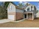 Side view of charming two-story home with a two-car garage and brick accents at 2704 River Summit Ln, Decatur, GA 30034