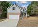 Charming two-story home with a two-car garage, brick accents, and a well-maintained front yard at 2704 River Summit Ln, Decatur, GA 30034