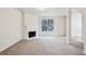 Bright and airy living room featuring neutral walls, carpeting, and a cozy fireplace at 2704 River Summit Ln, Decatur, GA 30034