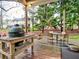 Backyard deck with a grill, dining table, and a playset in the distance at 2751 Davis Rd, Marietta, GA 30062