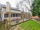 View of the back of the home with a wooden deck and grassy backyard at 2751 Davis Rd, Marietta, GA 30062