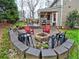 A charming backyard featuring a stone fire pit, patio, comfortable seating, and beautiful landscaping at 2751 Davis Rd, Marietta, GA 30062