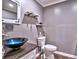 Stylish powder room featuring granite counters, a vessel sink, modern fixtures, and wood-look floors at 2751 Davis Rd, Marietta, GA 30062