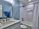 Bathroom featuring blue walls, white cabinets and a tub/shower combo with white subway tile at 2751 Davis Rd, Marietta, GA 30062