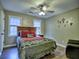 Bedroom featuring a queen bed with dark wood floors, two windows, and artwork at 2751 Davis Rd, Marietta, GA 30062