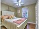 Bedroom featuring a queen bed with white headboard, lots of pillows, and an armoire at 2751 Davis Rd, Marietta, GA 30062