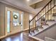 Inviting foyer with hardwood floors, staircase, and a front door with glass sidelights at 2751 Davis Rd, Marietta, GA 30062